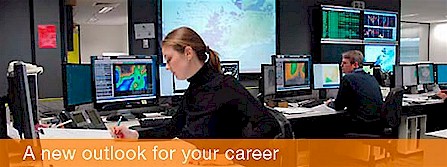 Two forecasters working at their workstations